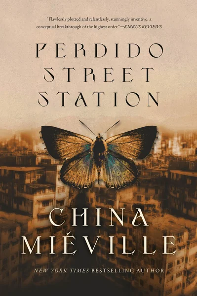 Book cover for "Perdido Street Station" by China Miéville, showing a large moth with iridescent blue underwings above a hazy sepia cityscape.