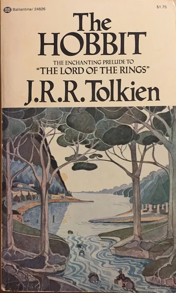 Cover of "The Hobbit" by J.R.R. Tolkien. Art features a serene landscape with a river, trees, and mountains under a soft, pastel-colored sky.