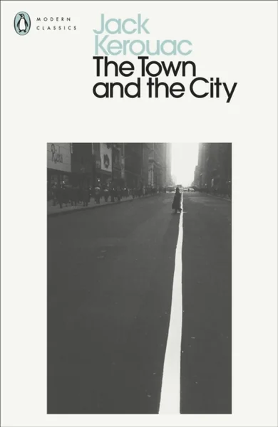 Penguin Modern Classics cover of "The Town and the City" by Jack Kerouac, showing a black-and-white photo of a lone figure walking down a city street's centerline.